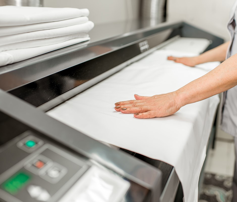 Linen table cloth being pressed